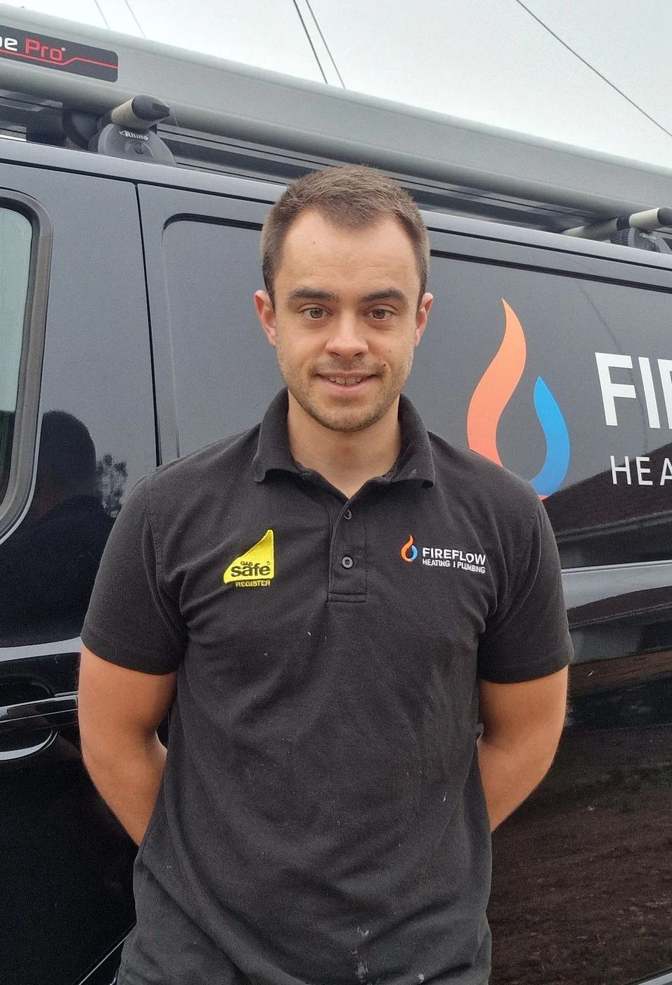 Bradley Harrison, Gas Safe registered engineer and founder of Fireflow Heating & Plumbing, in front of his signwritten van
